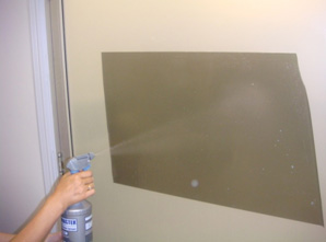 Spray the entire adhesive side of window film with soap water solution