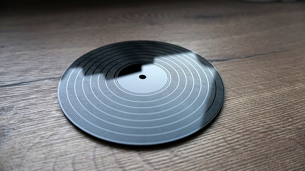 An acrylic design, cut and engraved by a GCC laser engraver, inspired by the look of a vinyl LP record.